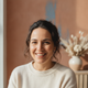 Headshot of a smiling German woman in her mid-30s, looking content and trustworthy.